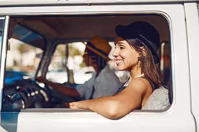 Buy stock photo Shot of two happy young friends enjoying a relaxing road trip