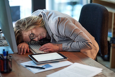Buy stock photo Cropped shot of a businesswoman sleeping at her desk while working late in the office
