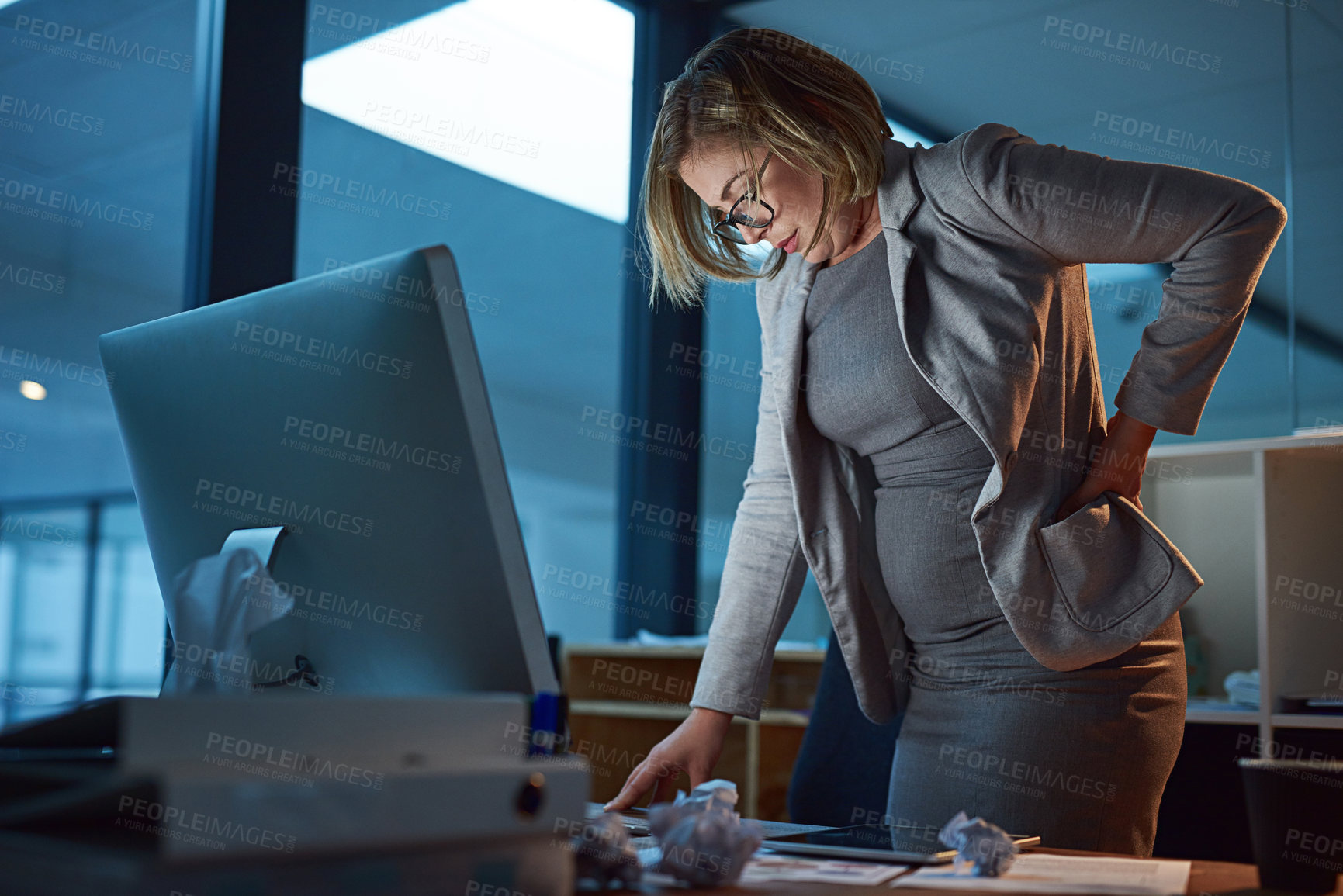 Buy stock photo Business woman, back injury and night with pain for accident, strain or overworked at office. Frustrated female person, employee or sore spine in ache or muscle tension from working late at workplace