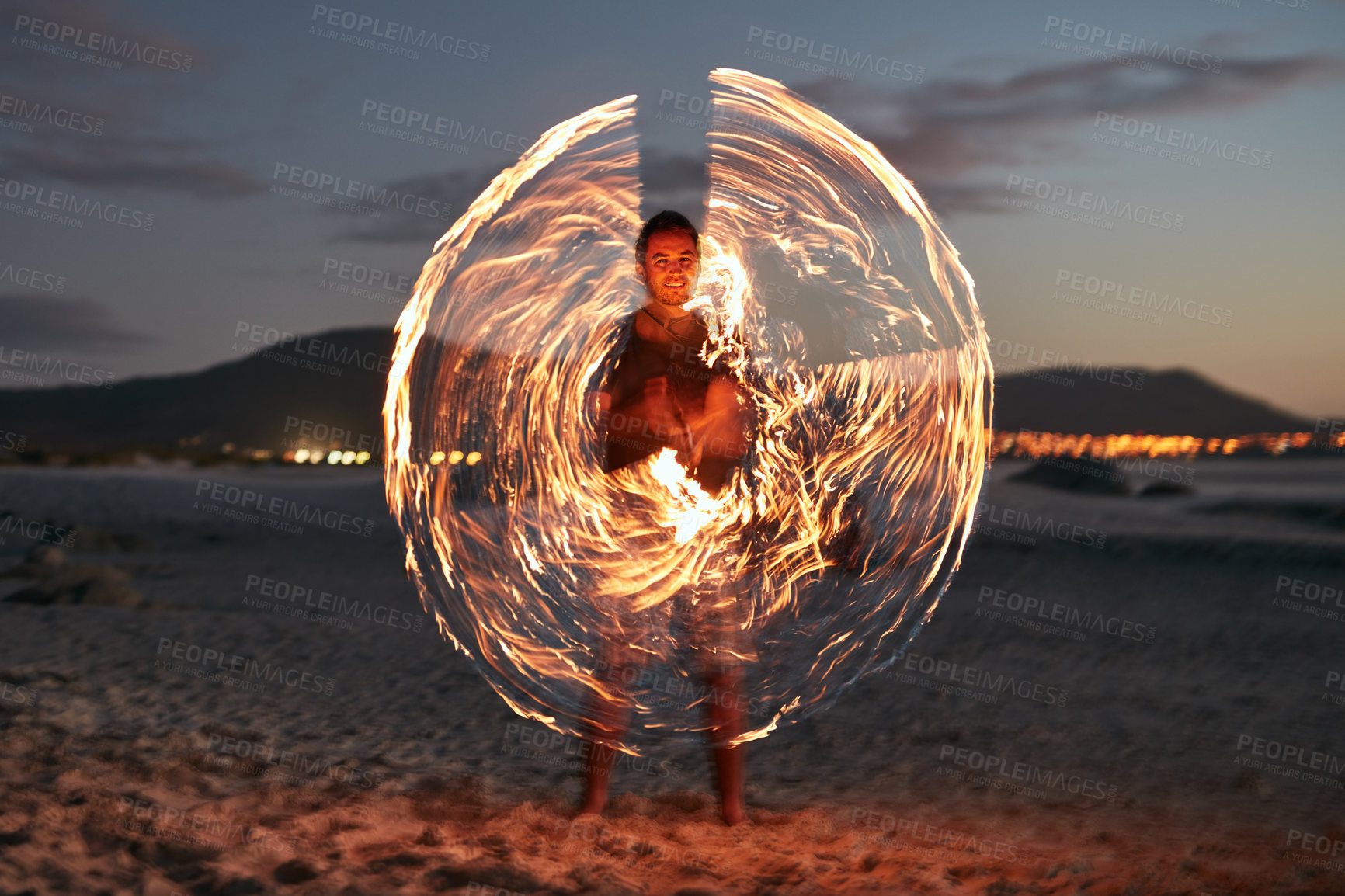 Buy stock photo Night, smile and sparkler with man on beach for island holiday, travel or tropical vacation. Fire dance, long exposure and firework with person on sand at ocean or sea for fun or paradise getaway