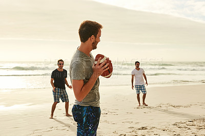 Buy stock photo Shot of a group of happy young friends playing with a ball on the beach