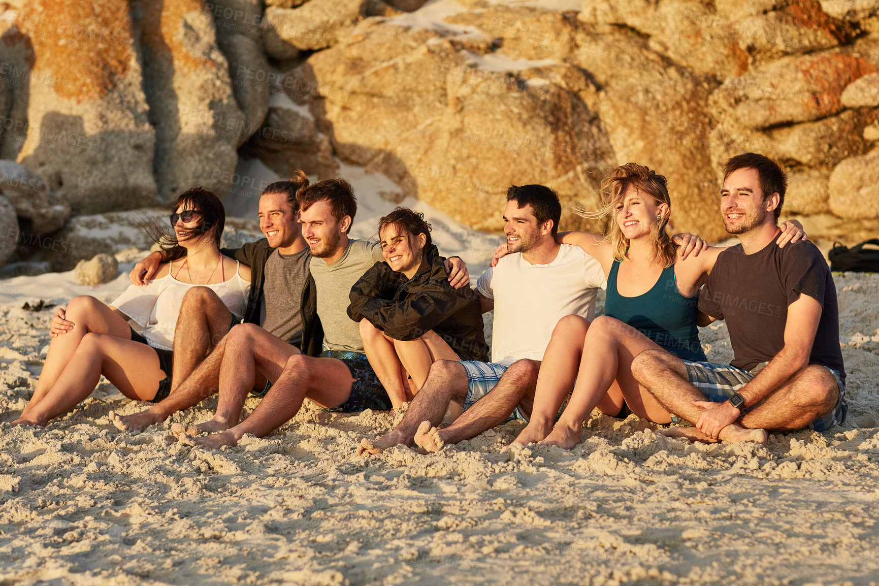 Buy stock photo People, beach and gathering together for picnic or social as friends on holiday, vacation or break. Group, relax and fun as community for summer trip, sunset or outdoor adventure on island in Greece