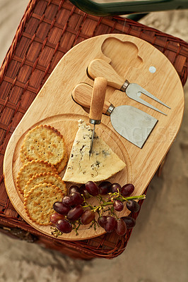 Buy stock photo High angle shot of a cheese platter at a beach picnic