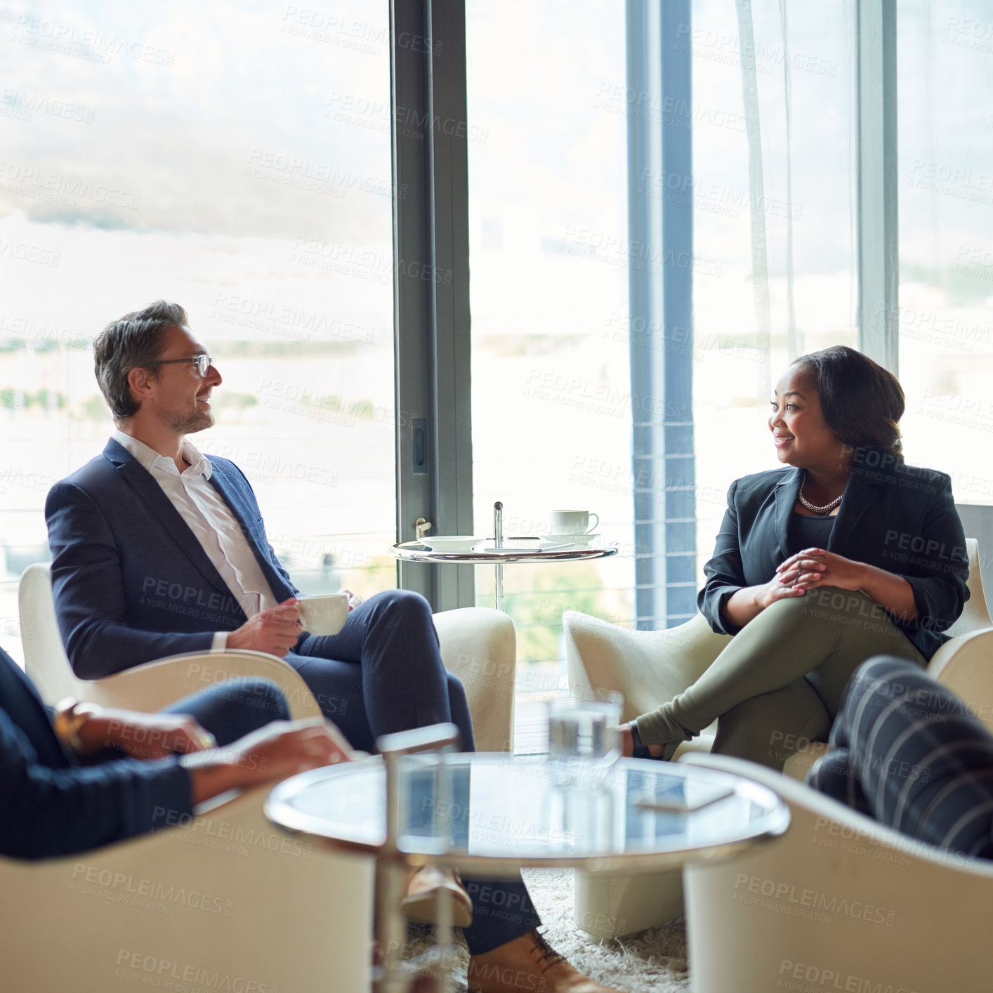 Buy stock photo Shot of a group of business people having a discussion in a modern office