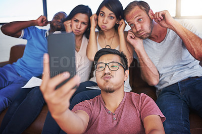 Buy stock photo Business people, funny and selfie in office with peace, diversity and sofa for playful, joy or fun. Creative agency, joke and team in workplace with memory for collaboration, cooperation or startup 