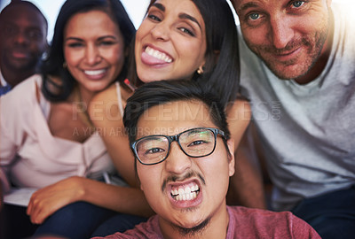 Buy stock photo Portait of a carefree group of creative colleagues posing together in the office