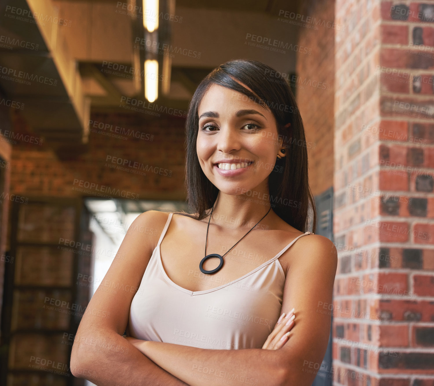 Buy stock photo Portrait of a confident young creative posing in the hallway in her office