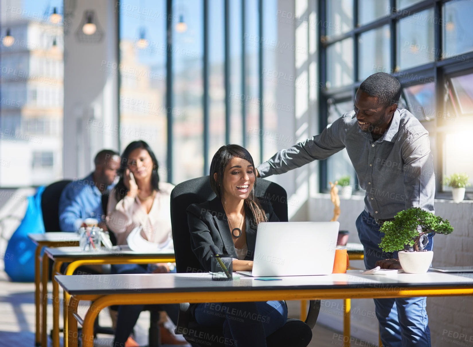 Buy stock photo Shot of two creative colleagues brainstorming their latest project together in the office