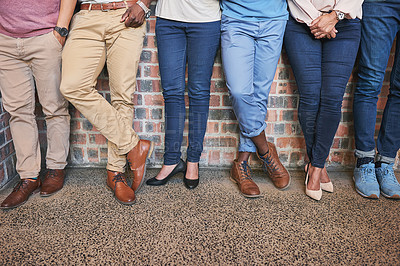Buy stock photo Low angle shot of a group of creative coworkers' legs as they stand in the office together