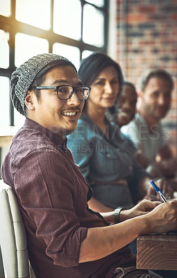 Buy stock photo Shot of a young man with a  team of entrepreneurs collaborating in a modern office