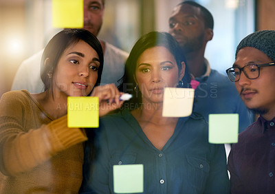 Buy stock photo Shot of a team of entrepreneurs collaborating in a modern office 