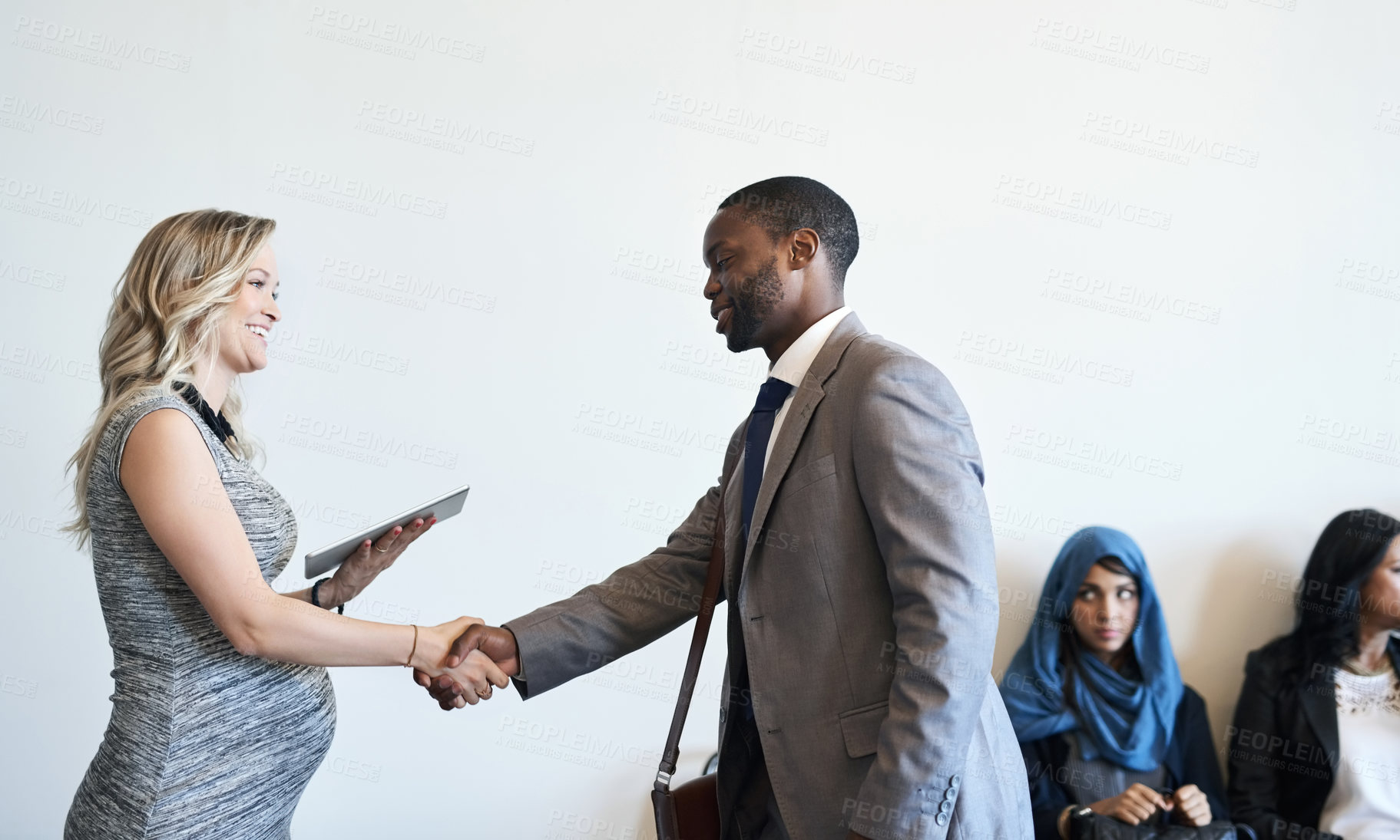 Buy stock photo Shot of a well-dressed candidate shaking hands with his interviewer before an interview