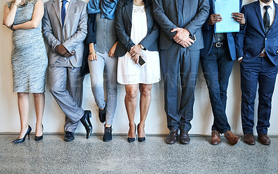 Buy stock photo Cropped shot of a group of unidentifiable businesspeople standing in line while waiting to be interviewed