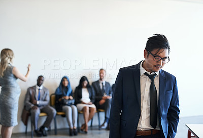 Buy stock photo Shot of a dejected job applicant leaving the waiting room after his interview