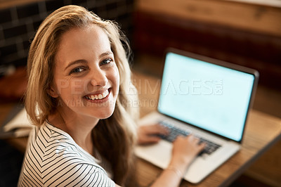 Buy stock photo Portrait of a happy young student using her laptop to study at a cafe table