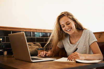 Buy stock photo Shot of a happy young student using her laptop to study at a cafe table