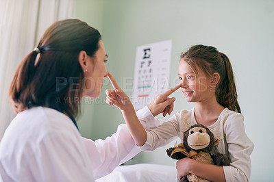 Buy stock photo Doctor, girl child and touch nose in clinic, care and playful with medical service, check or exam with smile. Woman, pediatrician and kid with monkey toys, happy or connection for health at hospital