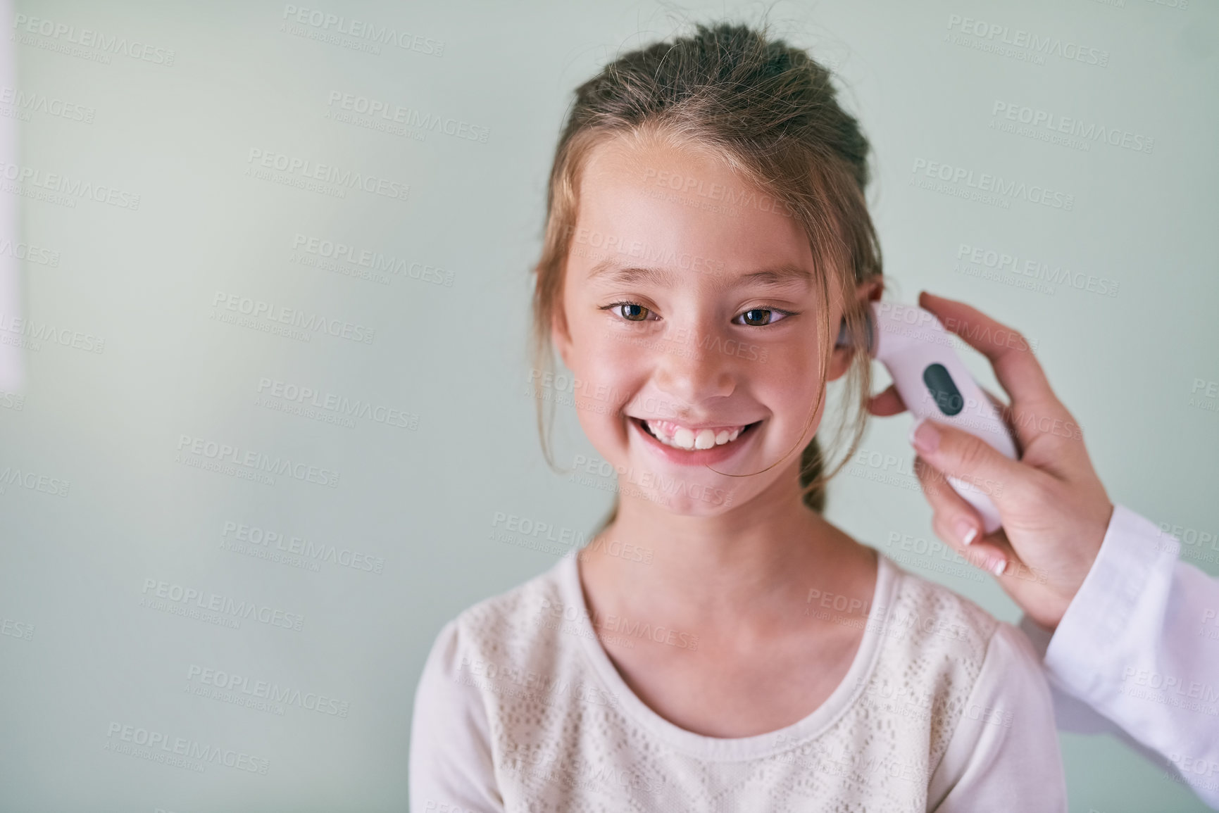 Buy stock photo Healthcare, children and a girl at the pediatrician for a temperature checkup or appointment in the hospital. Medical, ear and thermometer with an adorable female child sitting in a health clinic