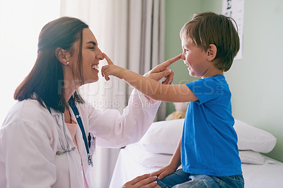 Buy stock photo Woman doctor, playing and child at a hospital for healthcare and medical consultation. Fun, nose poke and pediatrician working with a laugh and happiness in a clinic with boy patient with exam