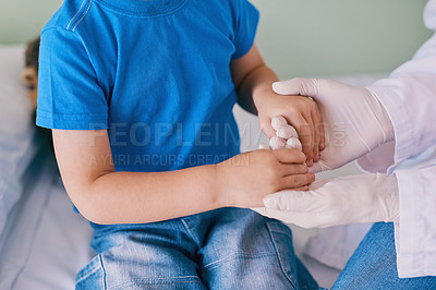Buy stock photo Shot of a little boy holding his doctor's hands