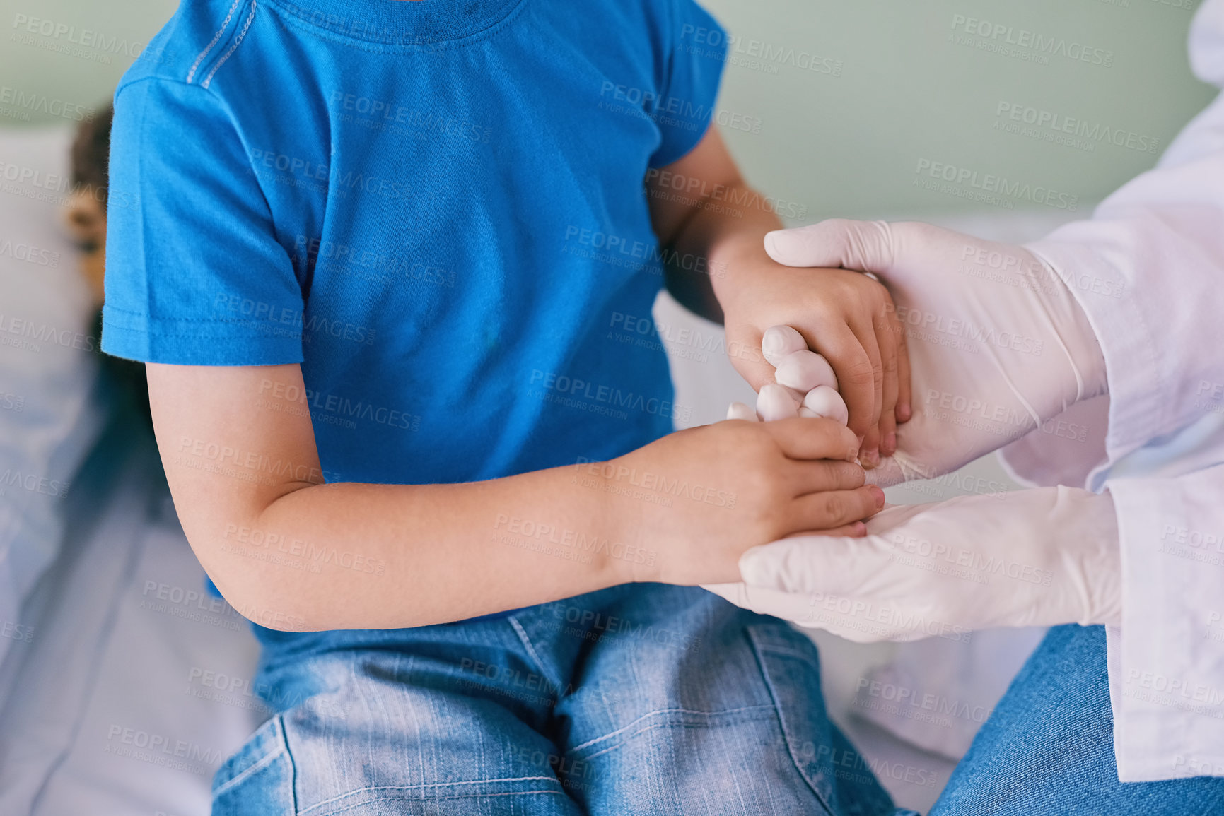 Buy stock photo Shot of a little boy holding his doctor's hands