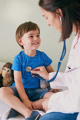 Buy stock photo Shot of a female doctor checking her young patient's heart rate