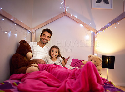 Buy stock photo Portrait of a father reading a book with his little daughter in bed at home