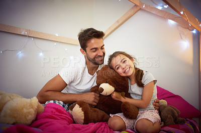 Buy stock photo Cropped shot of a father and his little daughter bonding together at home