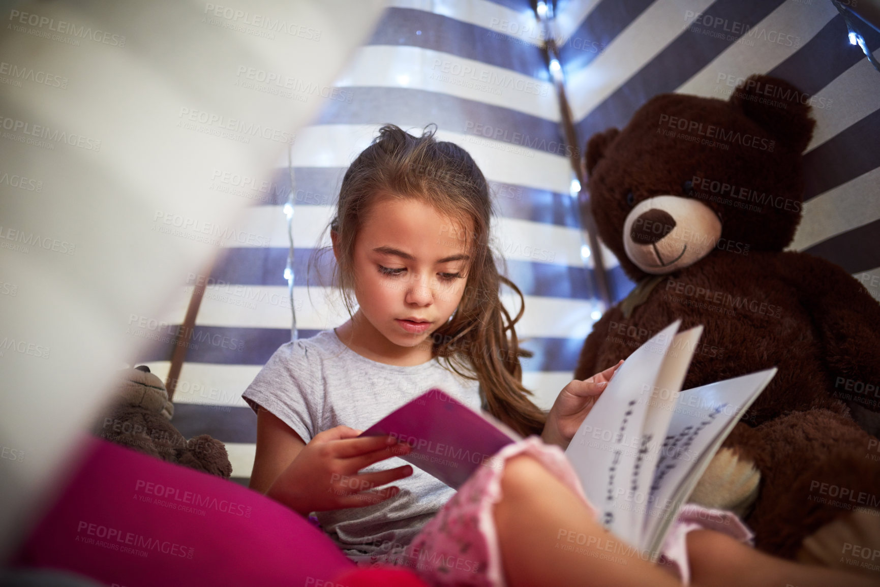 Buy stock photo Learning, child and reading book in home tent for education, language development or knowledge in bedroom. Girl, fairytale and studying fantasy story, information or hobby with teddy bear in house