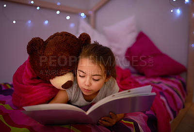 Buy stock photo Cropped shot of a little girl reading a book in bed with her teddybear