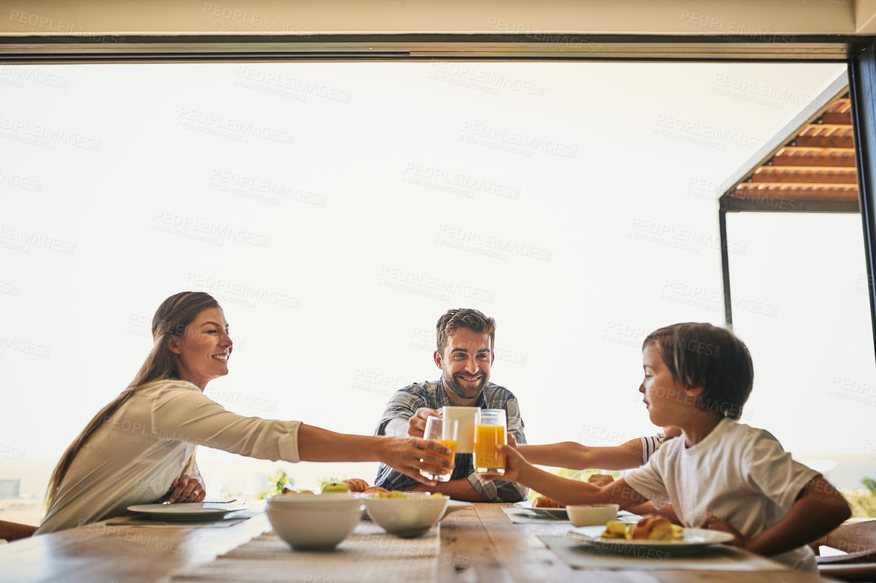 Buy stock photo Family, breakfast and toast in house with juice, cereal and fruit for health or nutrition by table. Woman, dad and kids together in home with food for wellness, brunch or bonding with support or love