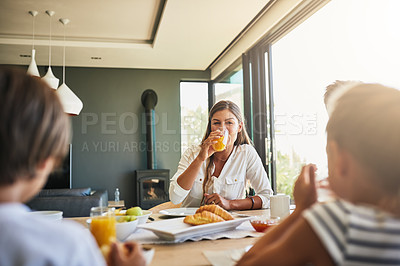 Buy stock photo Shot of a mother having breakfast with her children at home