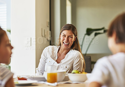 Buy stock photo Shot of a mother having breakfast with her children at home