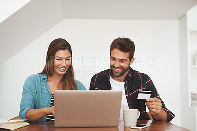 Buy stock photo Shot of a happy couple of entrepreneurs working together from their home office