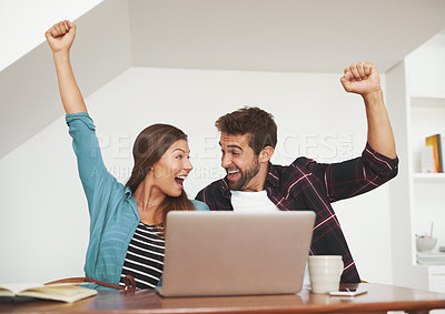 Buy stock photo Shot of a couple of happy entrepreneurs celebrating an achievement in their home office