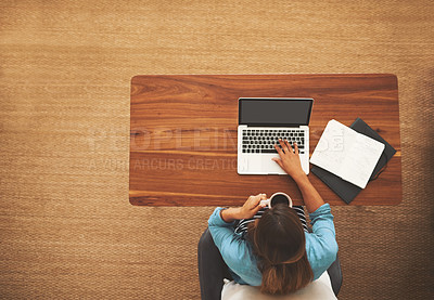 Buy stock photo High angle shot of an unidentifiable freelancer working from her desk at home