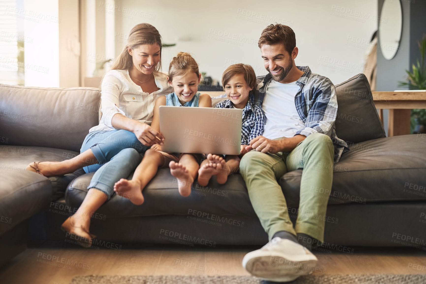 Buy stock photo Family, laptop and kids with parents on a living room sofa with education game online. Mom, dad and young children together with bonding, parent care and love in a house watching a video on computer