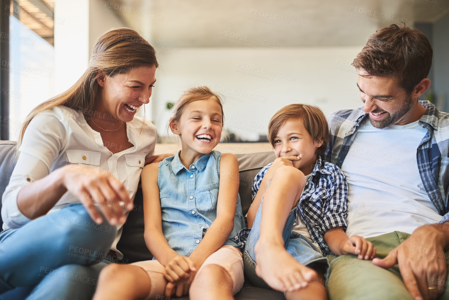 Buy stock photo Happy family, children and laughing on sofa with love, healthy relationship and bonding with joke in home. Kids, parents and smile for comedy storytelling with safety, calm weekend and relax together