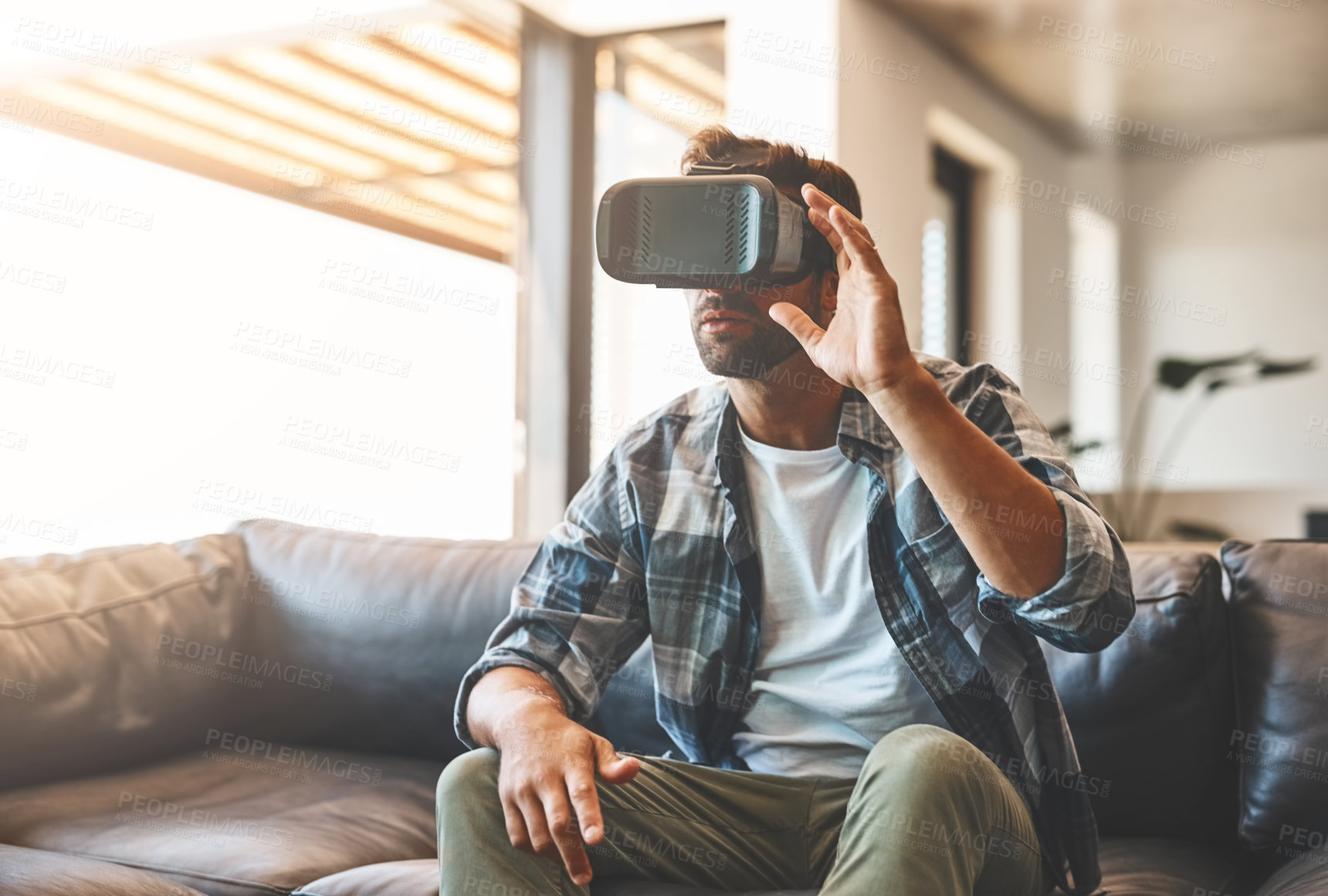 Buy stock photo Creative, man and virtual reality headset in home lounge of cyber experience, metaverse system or gaming connection. 
Gamer, VR or games in living room with future, innovation and ui technology