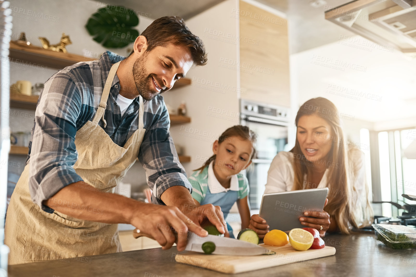 Buy stock photo Family, cooking and diet with people, tablet and online for recipe or ingredients on kitchen counter for dinner. Healthy, food and meal prep for nutrition, together or bonding in clean eating at home