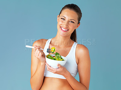 Buy stock photo Woman, portrait and happy, salad and vegetable for health and nutritionist in isolated blue background. Face, vegan and wellness, diet with female model in studio and tasting organic food in bowl