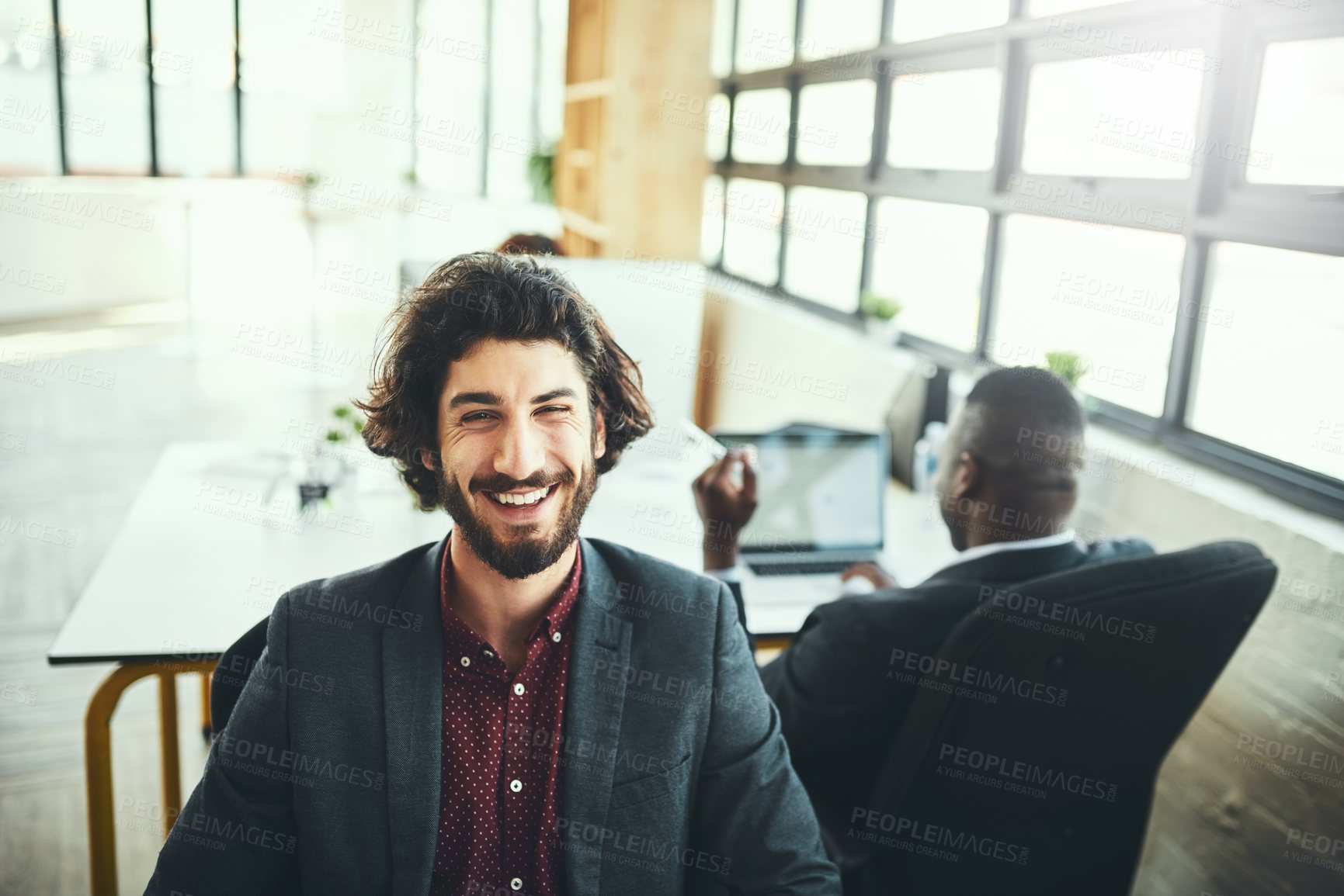 Buy stock photo Cropped portrait of a handsome young businessman working in his office