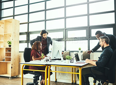 Buy stock photo Cropped shot of a group of businesspeople working in their office