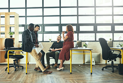 Buy stock photo Full length shot of a group of businesspeople having an informal meeting in their office