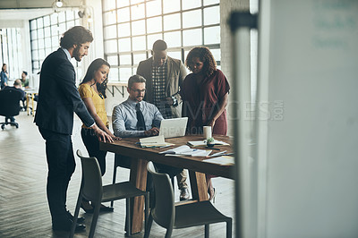 Buy stock photo Shot of a diverse team of businesspeople brainstorming their latest project together in the office