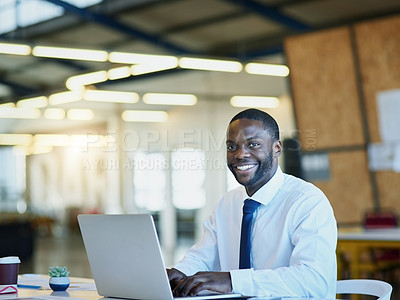 Buy stock photo Portrait of a businessman working on a laptop in an office