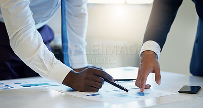 Buy stock photo Shot of two unrecognisable businessmen going through paperwork in an office