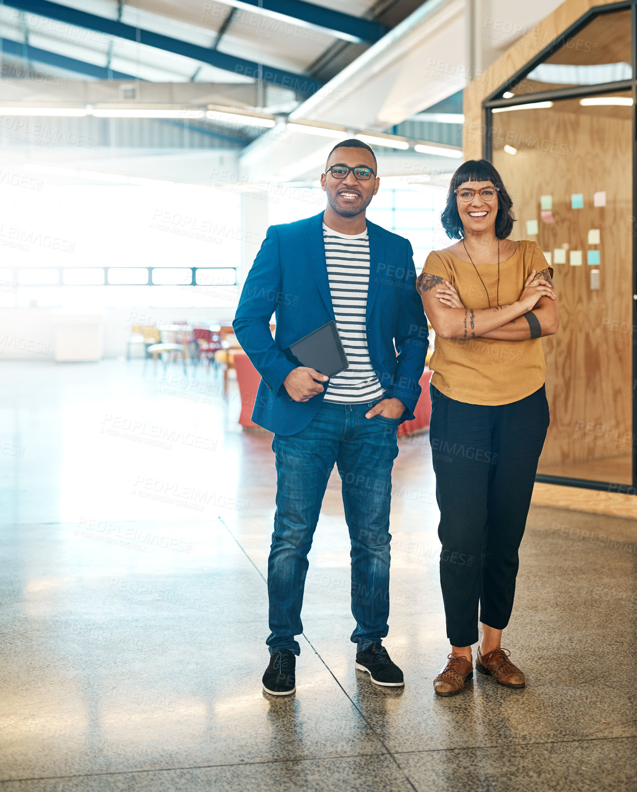 Buy stock photo Portrait of two young designers standing together in an office