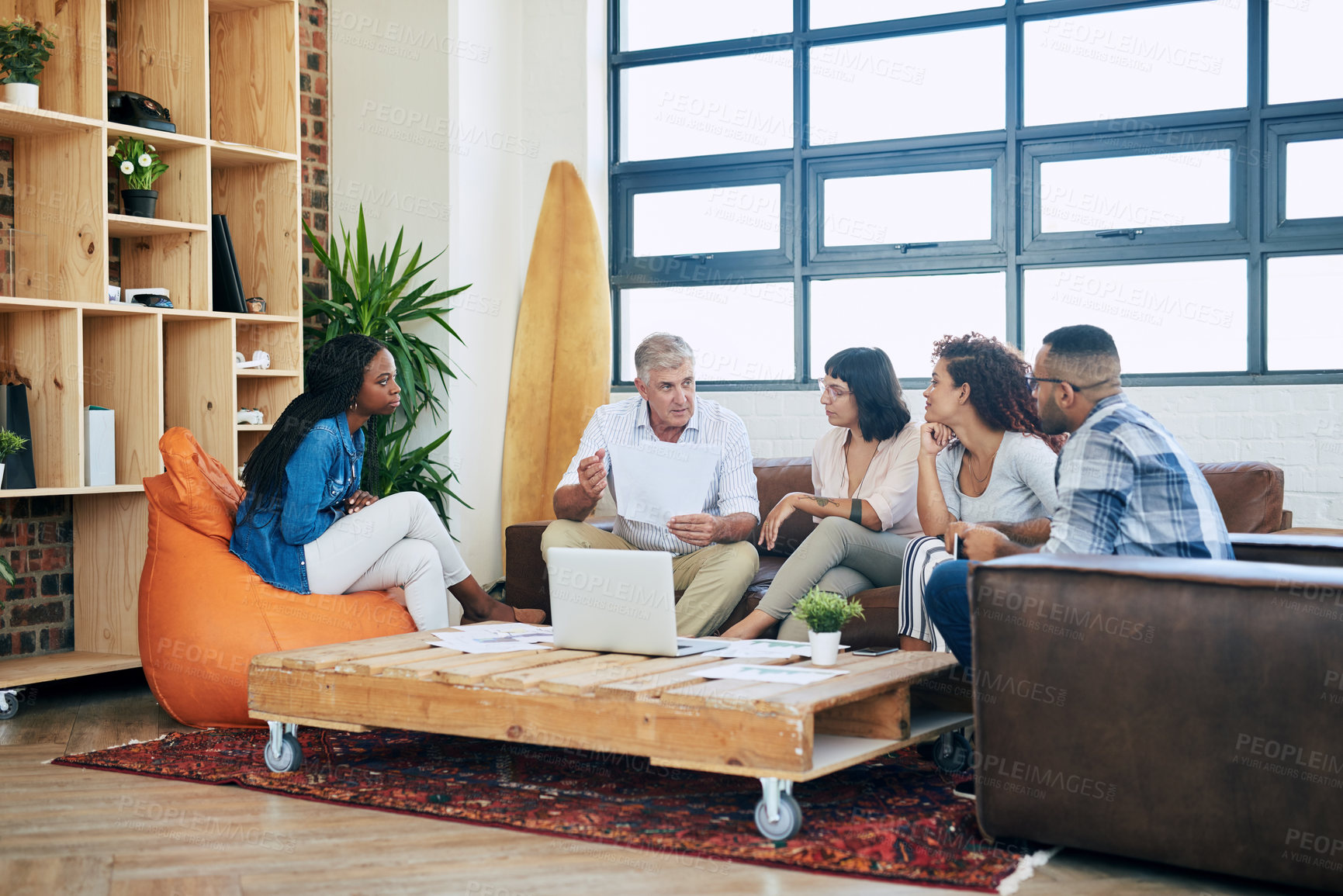 Buy stock photo Shot of a group of colleagues collaborating in a modern office