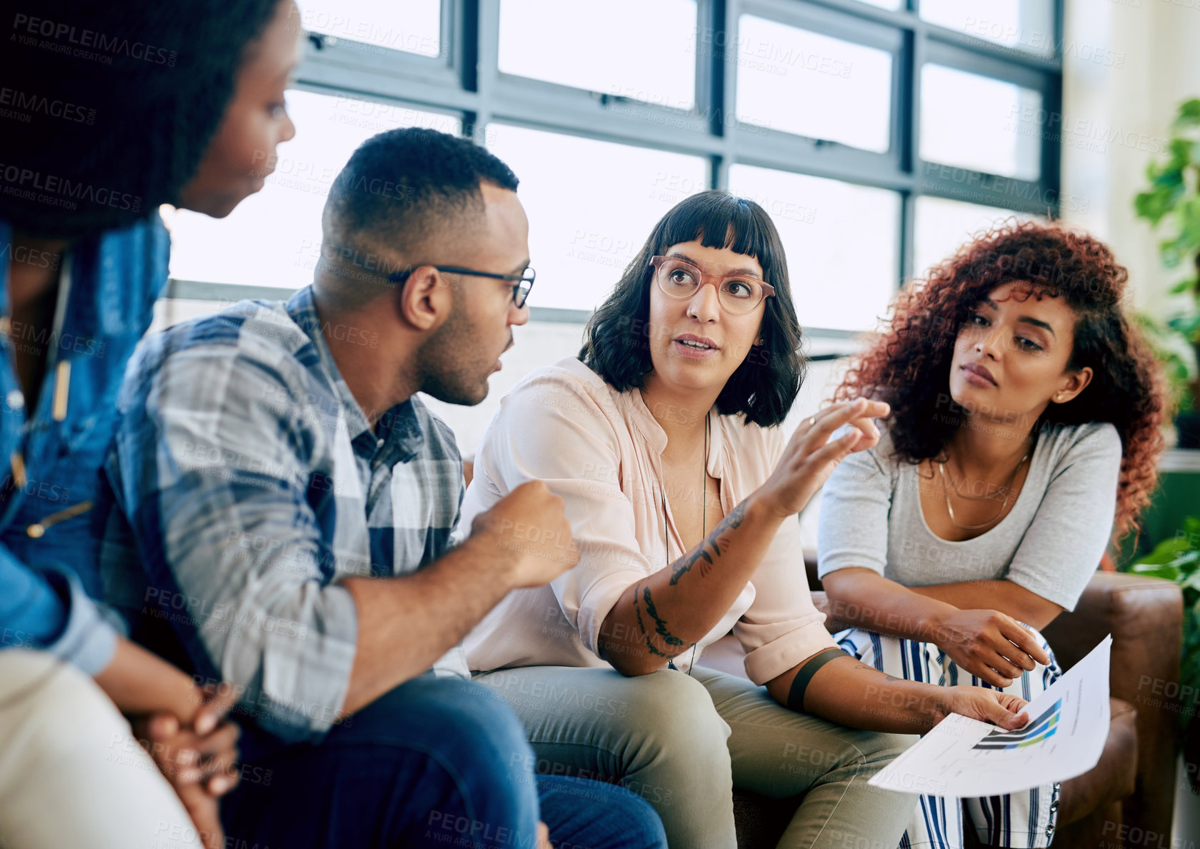 Buy stock photo Shot of a group of colleagues collaborating in a modern office